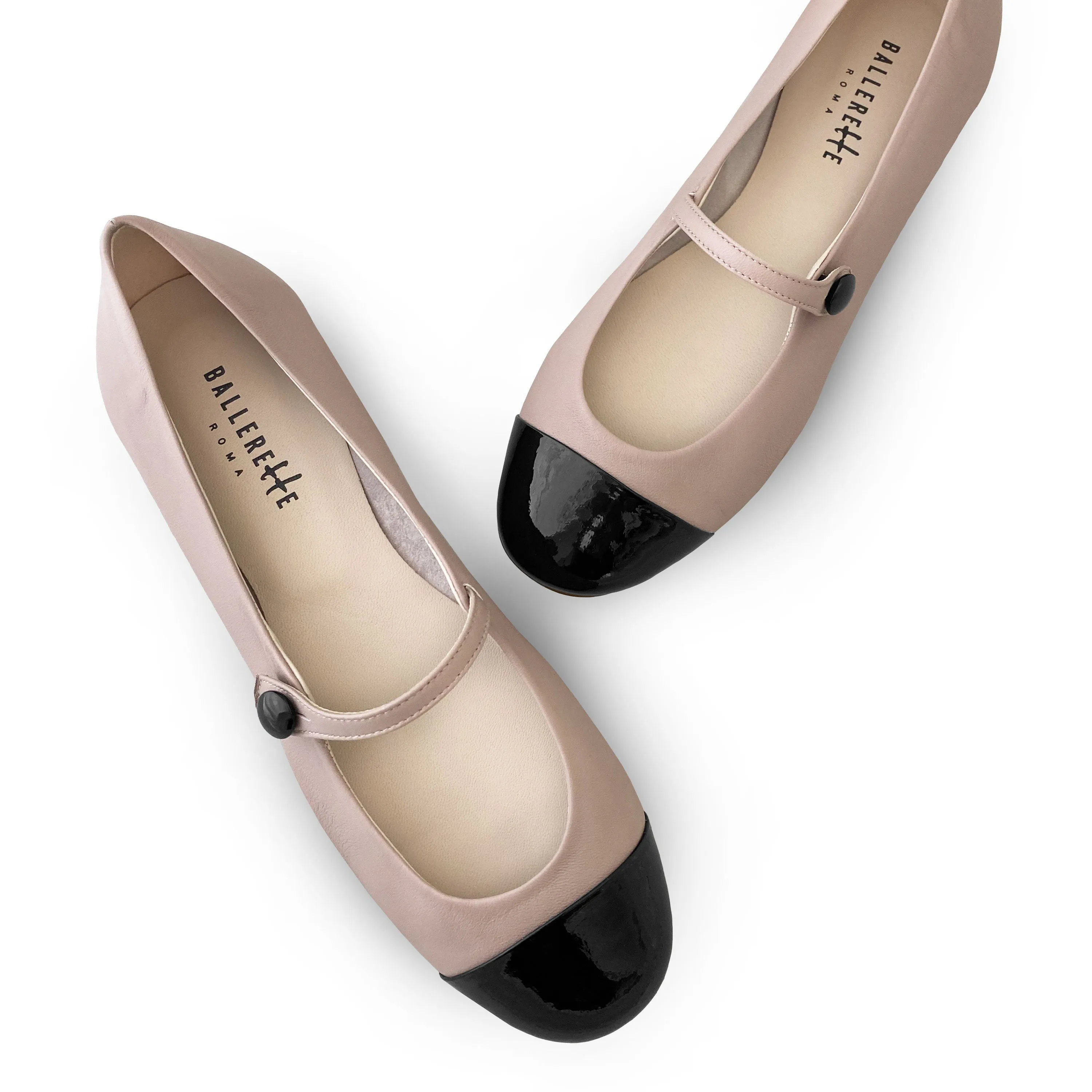 Powder pink ballet flats with black patent toe and strap