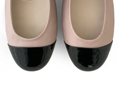 Powder pink ballet flats with black patent toe and strap